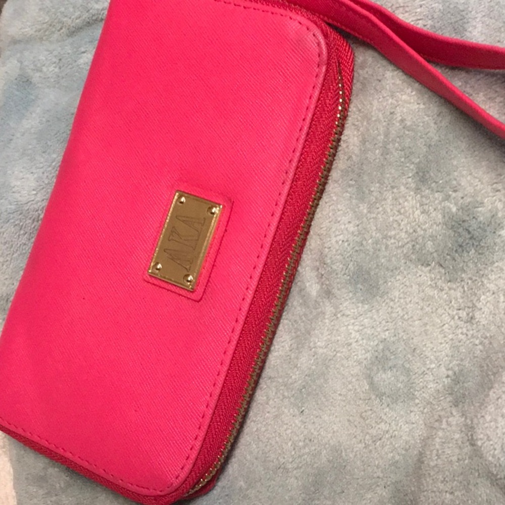 AKA small pink women’s WRISTLET Sleek design for carrying your essentials
